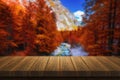 Empty wooden table for product placement or montage with focus to table top in the foreground, blurred autumn landscape in the Royalty Free Stock Photo