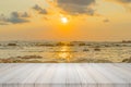 Empty wooden table or shelf wall with sunset or sunrise on sand Royalty Free Stock Photo