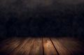 empty wooden table with smoke float up on dark background Royalty Free Stock Photo