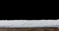 Empty wooden table snow covered with snowfall isolated on black background. Royalty Free Stock Photo