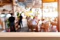 Empty wooden table space and blurry defocused restaurant and coffee shop Royalty Free Stock Photo