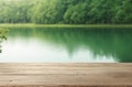 Empty Wooden Table with Summer Lakeside Forest Blur Background.