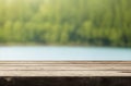 Empty Wooden Table with Summer Lakeside Forest Blur Background. Royalty Free Stock Photo