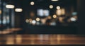 Empty wooden table surface with blurred cafe interior and bokeh lights Royalty Free Stock Photo