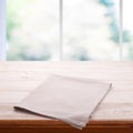 Empty wooden table with tablecloth. Napkin close up top view mock up. Kitchen rustic background with window. Royalty Free Stock Photo