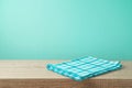 Empty wooden table with tablecloth over blue wall background Royalty Free Stock Photo