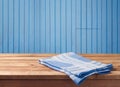 Empty wooden table with tablecloth over blue wood wall background. Background for food product display montage. Royalty Free Stock Photo