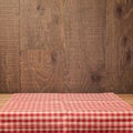 Empty wooden table with tablecloth over wooden rustic background Royalty Free Stock Photo