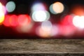 Empty Wooden table top with abstract night blurred bokeh city street lights background Royalty Free Stock Photo