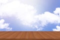 Empty wooden table top against a blue sky with sunlight background Royalty Free Stock Photo