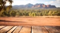 The empty wooden table top with blur background of Australian outback. Exuberant.