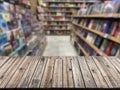 Empty wooden table top with Blur bookshelves in bookstore background. An empty tabletop in a library Royalty Free Stock Photo