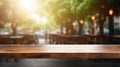 Empty wooden table top on blur of cafe, coffee shop, bar, background with lights bokeh can used for display or montage Royalty Free Stock Photo