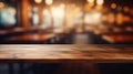 Empty wooden table top on blur of cafe, coffee shop, bar, background with lights bokeh can used for display or montage Royalty Free Stock Photo