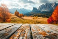 Empty wooden table top on blurred background of autumn colorful landscape in Dolomites - for display of your products Royalty Free Stock Photo