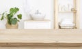 Empty wooden table top and blurred bathroom interior as background Royalty Free Stock Photo