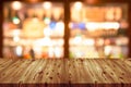 Empty wooden table top with blurred of coffee shop, cafe, bar background, Abstract background can be used for display or montage Royalty Free Stock Photo