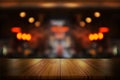 Empty wooden table top with blurred coffee shop or restaurant interior background Royalty Free Stock Photo