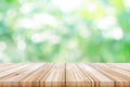 Empty wooden table top with blurred green natural background. Royalty Free Stock Photo