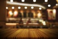 Empty wooden table top with blurred restaurant or cafe light background.
