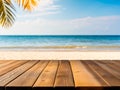 Empty wooden table top close-up with blur background of sea water, sand and summer sky. Royalty Free Stock Photo