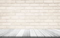 Empty wooden table top on cream brick wall background, Design wood terrace white. Perspective for show space for your copy and