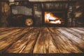 Empty wooden table top and home interior with fireplace and dark wall background. Empty space for your products. Royalty Free Stock Photo