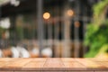 Empty wooden table top with lights bokeh on blur restaurant backgroundEmpty wooden table top with lights bokeh on blur restaurant