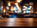 Empty wooden table top with lights bokeh on blur restaurant background. Royalty Free Stock Photo