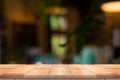 Empty wooden table top with lights bokeh on blur restaurant backgroundEmpty wooden table top with lights bokeh on blur restaurant Royalty Free Stock Photo