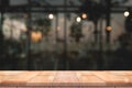 Empty wooden table top with lights bokeh on blur restaurant backgroundEmpty wooden table top with lights bokeh on blur restaurant Royalty Free Stock Photo