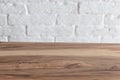 Empty wooden table over white brick wall Royalty Free Stock Photo