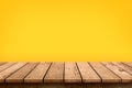 Empty wooden table top on pastel yellow colour background, used for display or montage your products