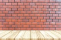 Empty wooden table top with red brick wall texture background. Royalty Free Stock Photo