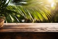 Empty wooden table top on tropic palm leaves background. Table top with copy space for product advertising