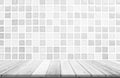 Empty wooden table top on white ceramic tile wall background, Design wood terrace white. Perspective for show space for your copy Royalty Free Stock Photo