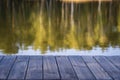 Empty wooden table and view of blurred calm lake background near spring forest. For product display Royalty Free Stock Photo