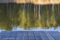 Empty wooden table and view of blurred calm lake background near spring forest. For product display Royalty Free Stock Photo