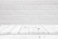 Empty wooden table with white brick wall background.