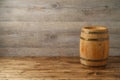Empty wooden table with wine barrel over wooden board background Royalty Free Stock Photo