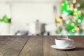 Empty wooden tabletop for display products and blurred kitchen with Christmas tree as background. Royalty Free Stock Photo