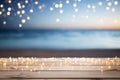 Empty Wooden Tabletop with Lights on Blurred Beach and Sea Background