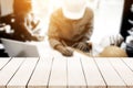 Empty wooden tabletop over business engineer working on his desk Royalty Free Stock Photo