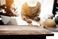 Empty wooden tabletop over business engineer working on his desk Royalty Free Stock Photo