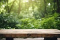 Empty Wooden Tabletop Podium in Garden Open Forest with Blurred Green Plants Background for Organic Product Presentation Royalty Free Stock Photo