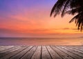 Wooden terrace over tropical island beach with coconut palm at sunset or sunrise time Royalty Free Stock Photo