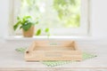 Empty wooden tray on table over blurred summer window background Royalty Free Stock Photo
