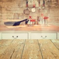Empty wooden vintage table over kitchen blurred background