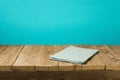 Empty wooden vintage table with tablecloth over blue wall background Royalty Free Stock Photo