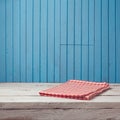 Empty wooden white table with checked tablecloth over blue wall Royalty Free Stock Photo